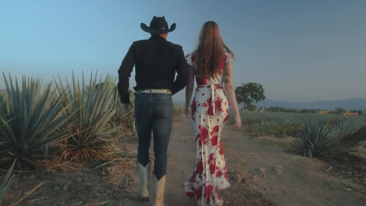 Stock Video Loving Couple Walking Through A Mexican Ranch Animated Wallpaper - Free Download