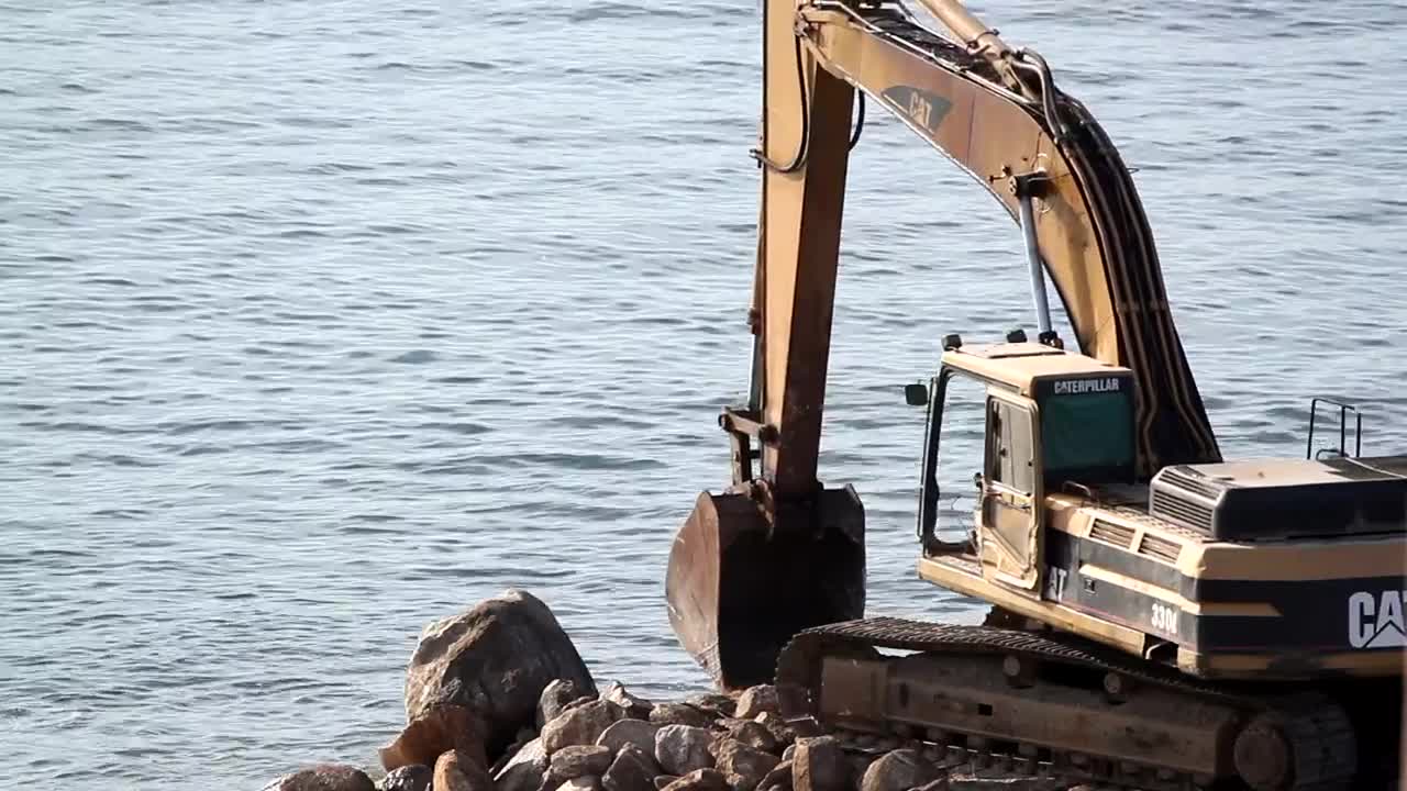 Stock Video Crane Digging On Rocks At The Sea Live Wallpaper For PC - Free Download