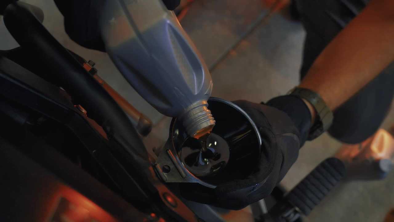 Stock Video Mechanic Pouring Oil Into An Engin Animated Wallpaper - Free Download