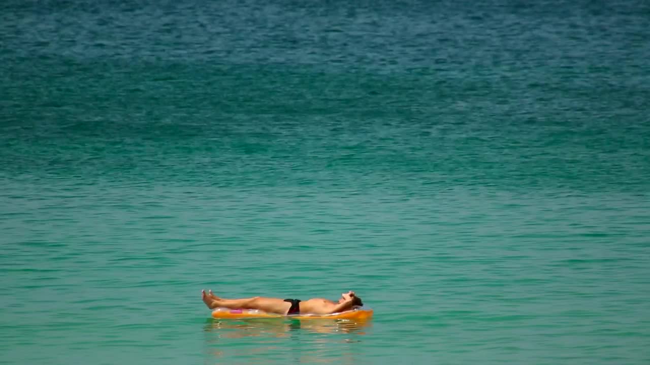 Stock Video Man Sunbathing In The Ocea Animated Wallpaper - Free Download