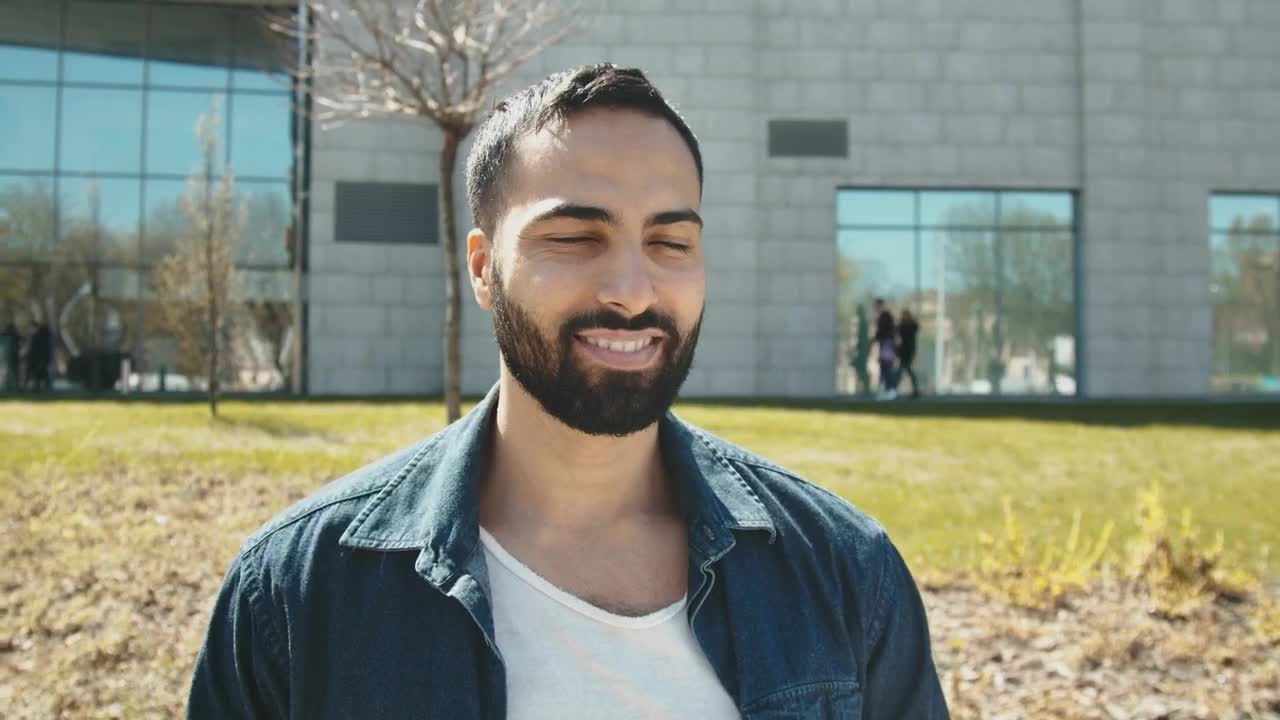 Stock Video Handsome Arab Man Smiles At Camera Outside Building Animated Wallpaper - Free Download