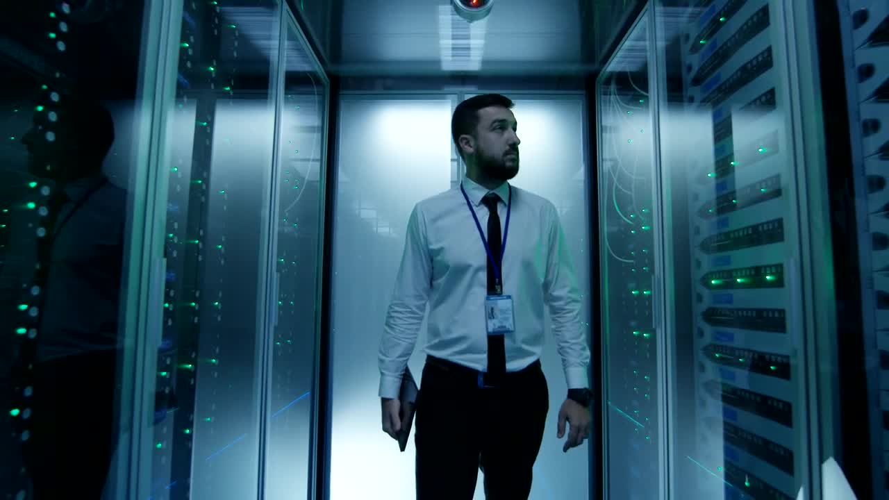Stock Video Engineer Walking In Data Center Hallway Live Wallpaper For PC - Free Download