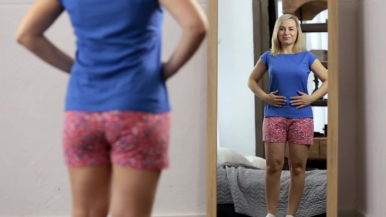 Stock Video Happy Woman While She Looks In The Mirror Animated Wallpaper - Free Download