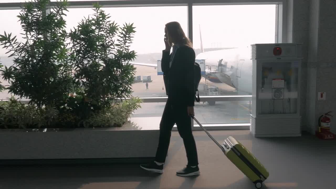 Stock Footage Woman Chatting On The Phone At An Airport Live Wallpaper - Free Download