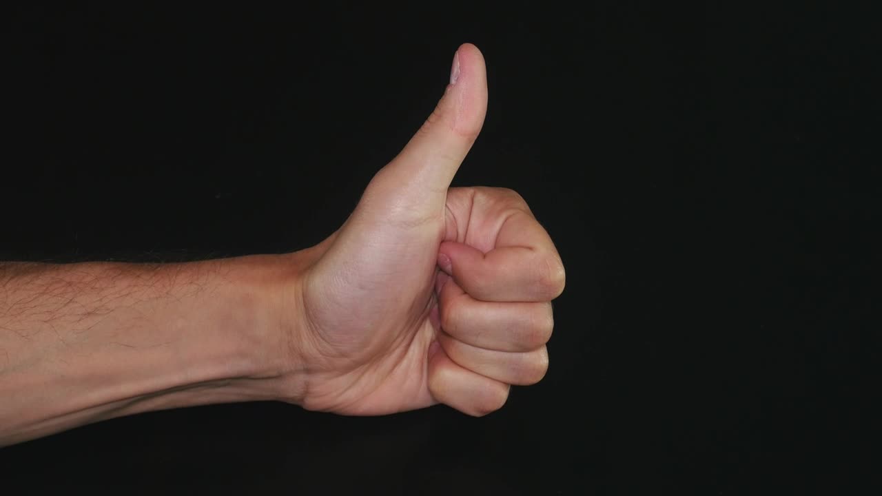 Free Video Stock thumbs up against a dark background Live Wallpaper - Free Download