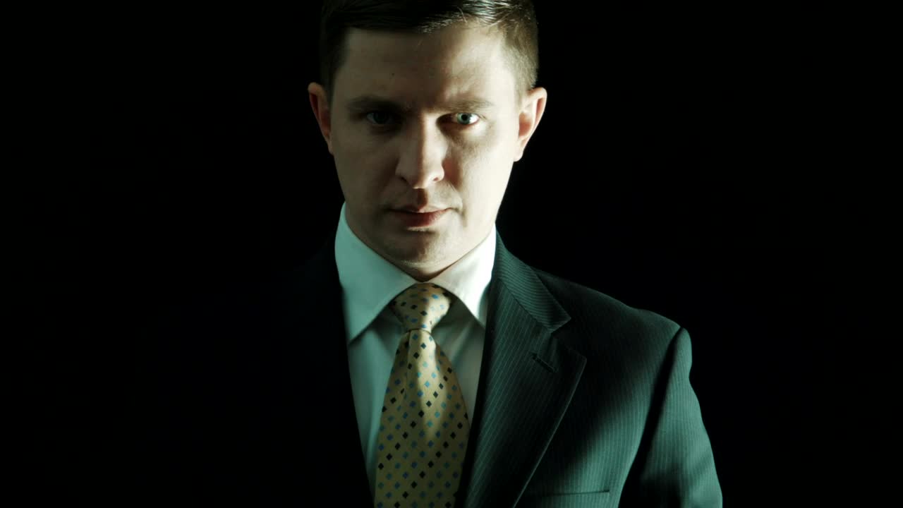 Stock Video Man In A Suit Putting Money On His Mouth Animated Wallpaper - Free Download
