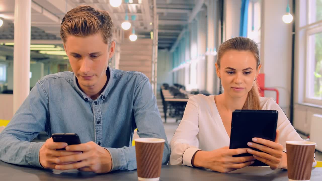 Stock Video Couple In A Cafe Connected On Their Devices Live Wallpaper For PC - Free Download