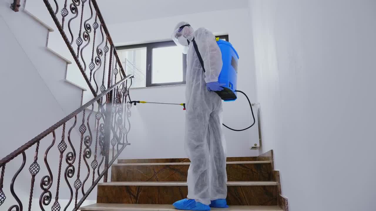 Stock Video Person In Ppe Sanitizing Building During Pandemic Live Wallpaper - Free Download