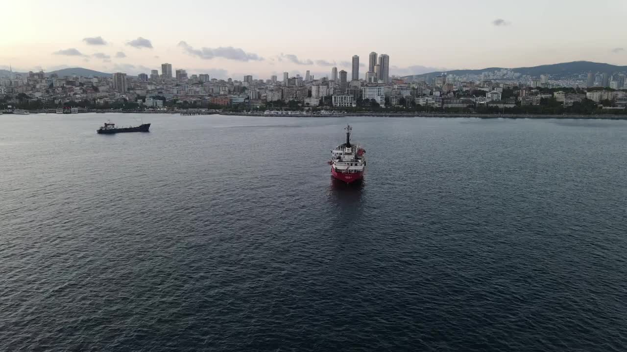 Stock Video Pair Of Cargo Ships Sailing Near A Coastal Town Live Wallpaper - Free Download