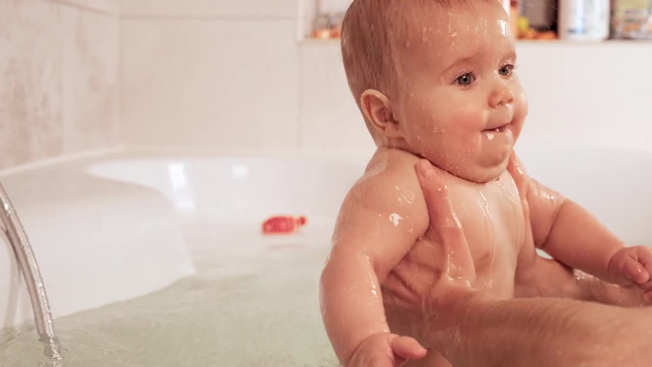 Stock Video Person Holding Baby In Bathtub With Both Hands Live Wallpaper - Free Download