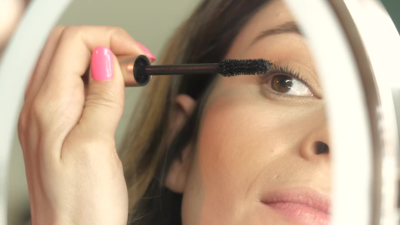 Stock Footage Woman Applies Mascara Live Wallpaper - Free Download