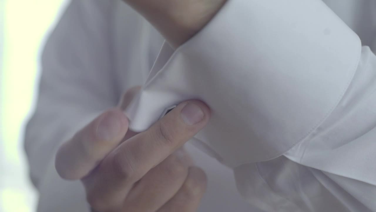 Stock Video Groom Placing Cufflinks On His Sleeves Live Wallpaper For PC - Free Download