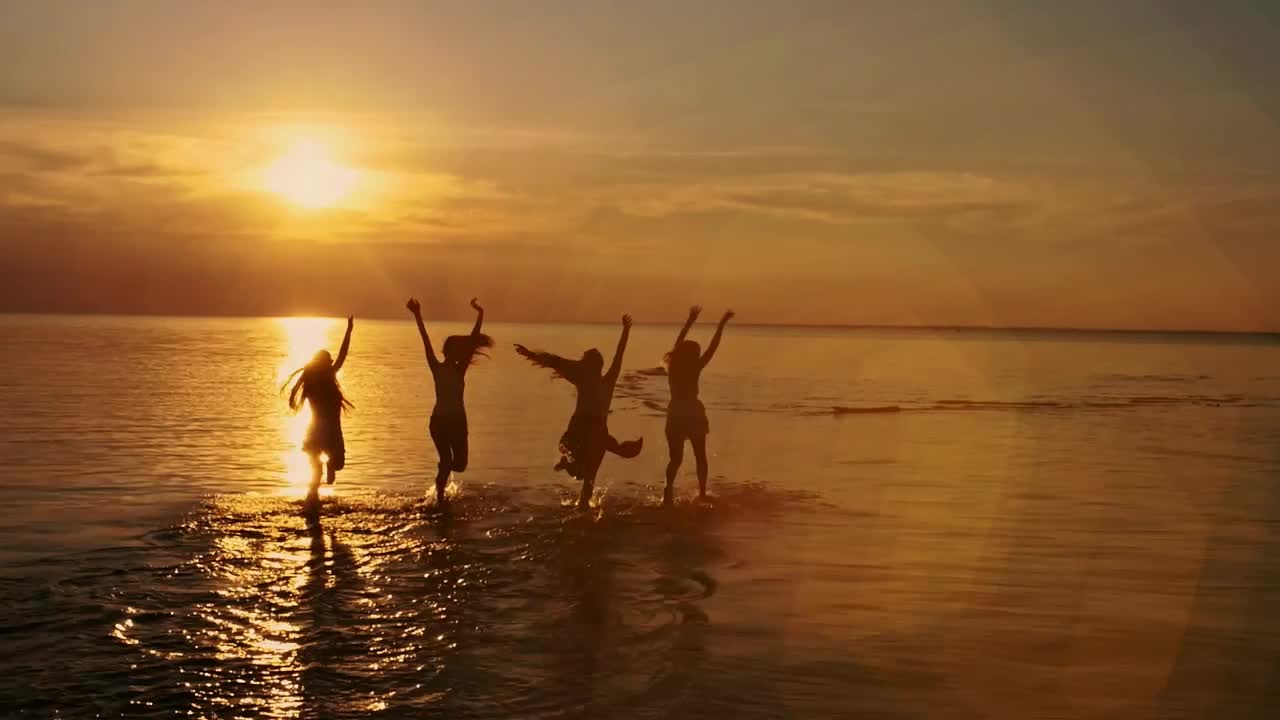 Free Video Stock teenager friends running in the seashore at sunset Live Wallpaper - Free Download