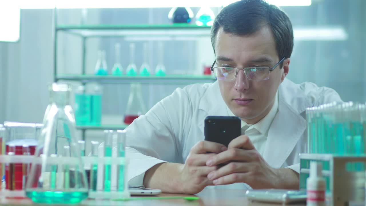 Stock Video Doctor In The Lab Looking At His Phone Live Wallpaper For PC - Free Download