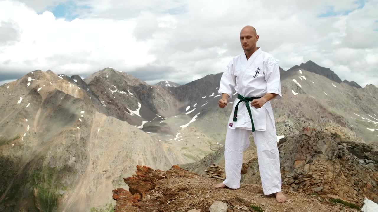 Stock Video Karate Black Belt Stands On Mountain Summit Animated Wallpaper - Free Download