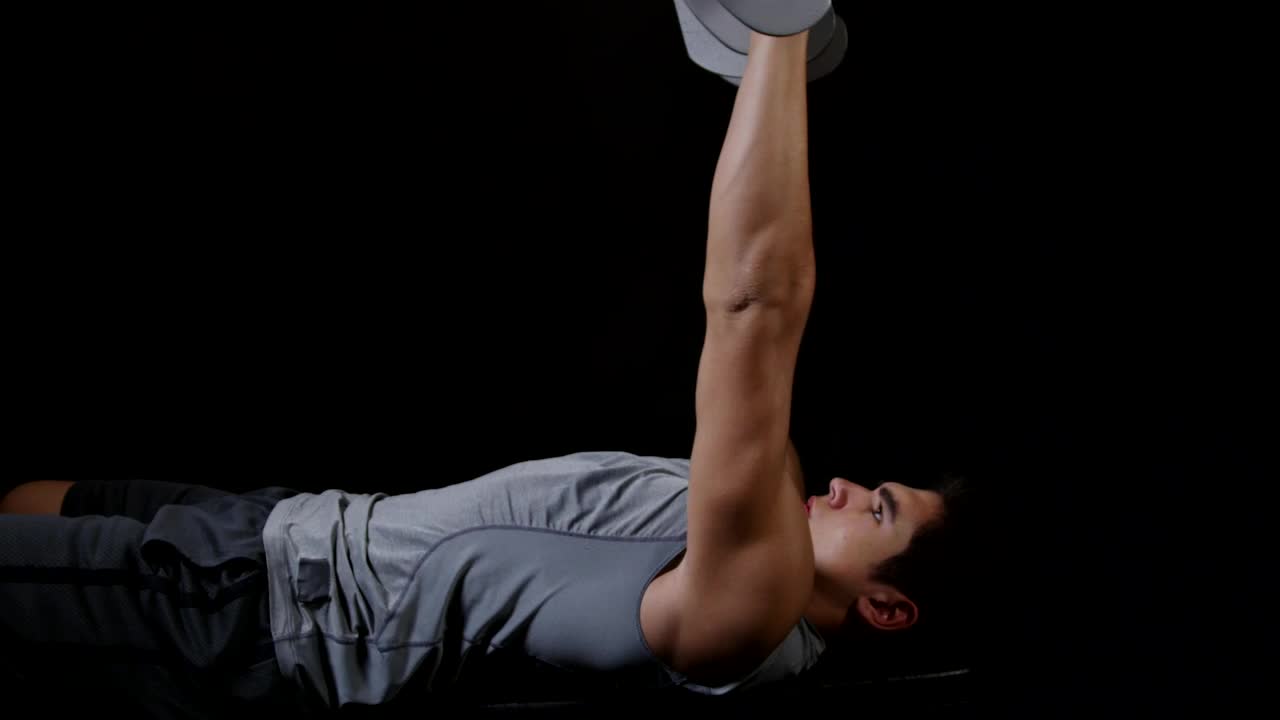 Stock Video Lifting Weights On A Dark Background Animated Wallpaper - Free Download