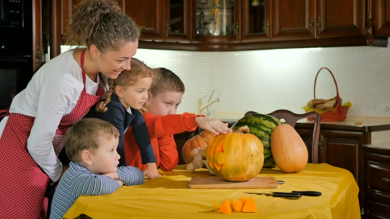 Stock Video Mom Helps Kids Prepare Jack O Lantern Pumpkin In Kitche Animated Wallpaper - Free Download