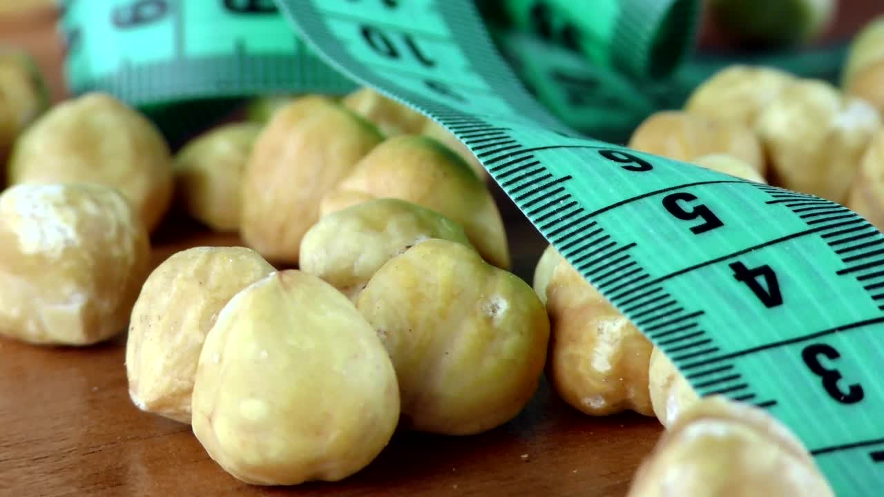 Stock Video Hazelnuts And Measuring Tape Macro Animated Wallpaper - Free Download