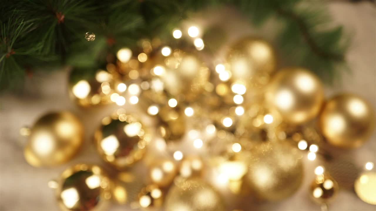Stock Video Hand Holds Out Christmas Ornament With Gold Bokeh Background Live Wallpaper For PC - Free Download