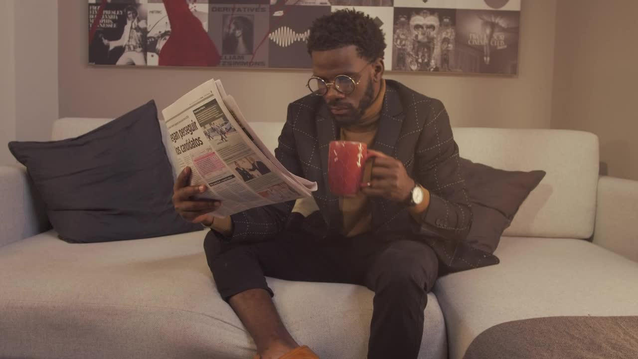 Stock Video Intellectual Man Reading The Newspaper With A Cup Of Coffee Animated Wallpaper - Free Download