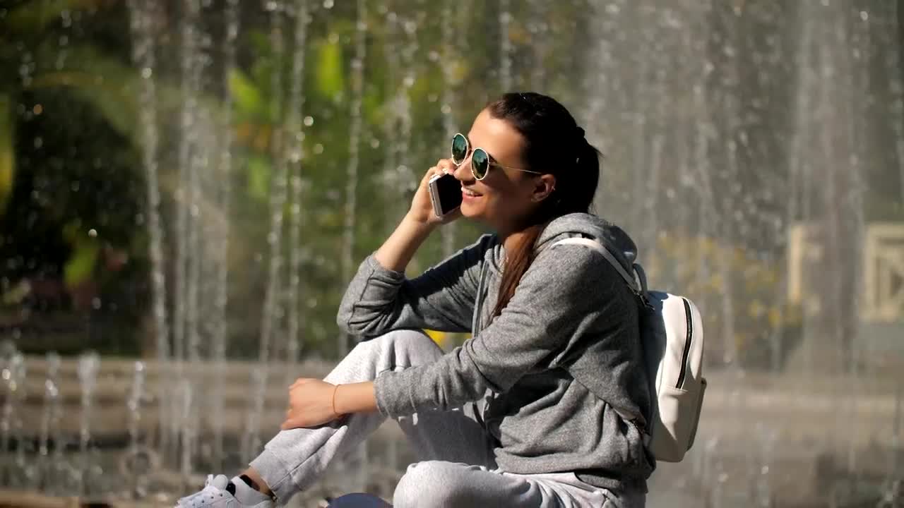Free Stock Video Woman On A Call Next To The Fountain In A Live Wallpaper - Free Download