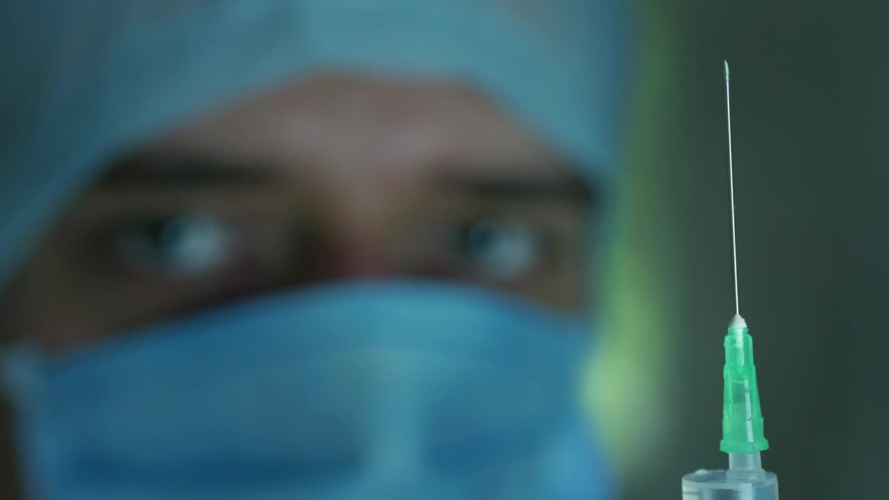 Free Stock Video Shallow Focus Of A Doctor Looking At The Syringe Live Wallpaper - Free Download