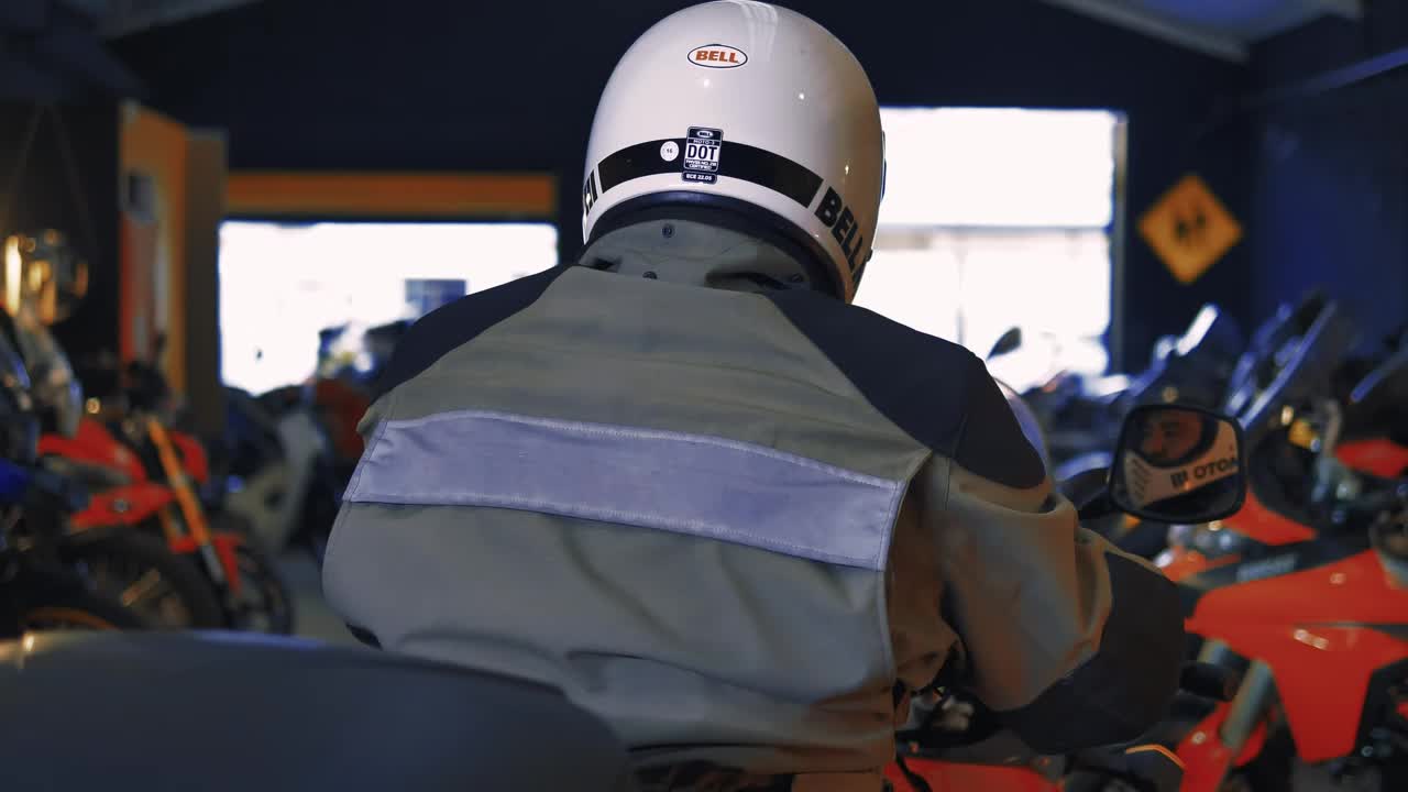 Stock Video Motorcyclist In A Workshop Full Of Motorcycles Live Wallpaper - Free Download