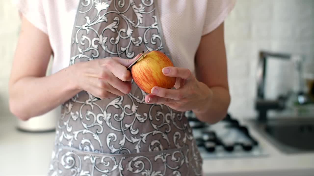 Stock Video Housewife Peeling An Apple With A Knife Animated Wallpaper - Free Download