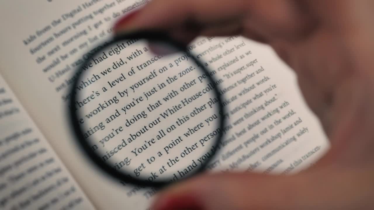 Stock Video Hand Of A Person Using A Magnifying Glass To Read Live Wallpaper For PC - Free Download
