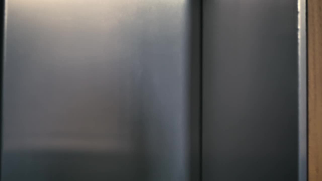 Stock Video Man Enters An Elevator Tapping His Wireless Earphones Animated Wallpaper - Free Download
