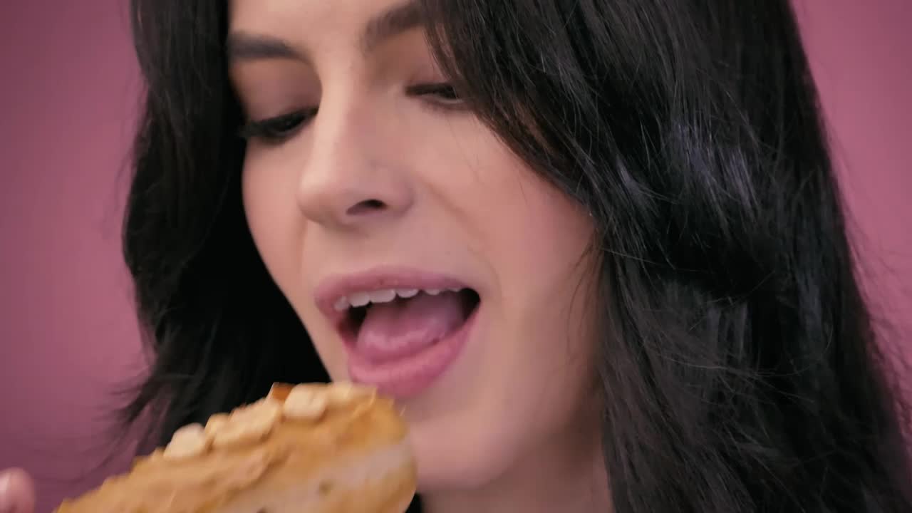 Stock Video Face Of A Girl While Biting Into A Peanut Donut Live Wallpaper For PC - Free Download