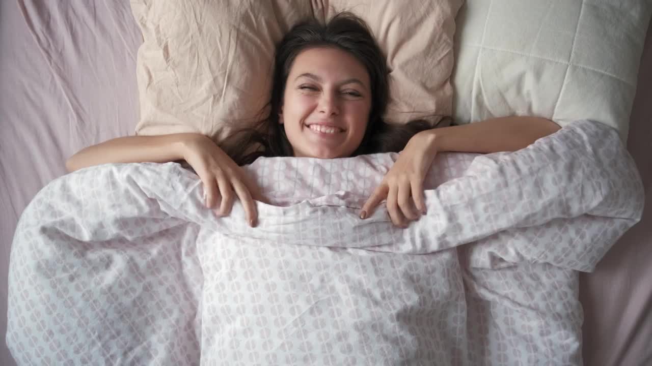 Free Video Stock top shot of a woman waking up in the morning Live Wallpaper - Free Download