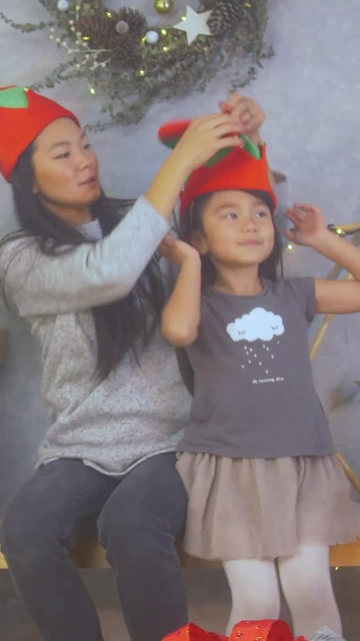 Stock Video Mother Trying On Christmas Hats With Her Little Daughte Animated Wallpaper - Free Download