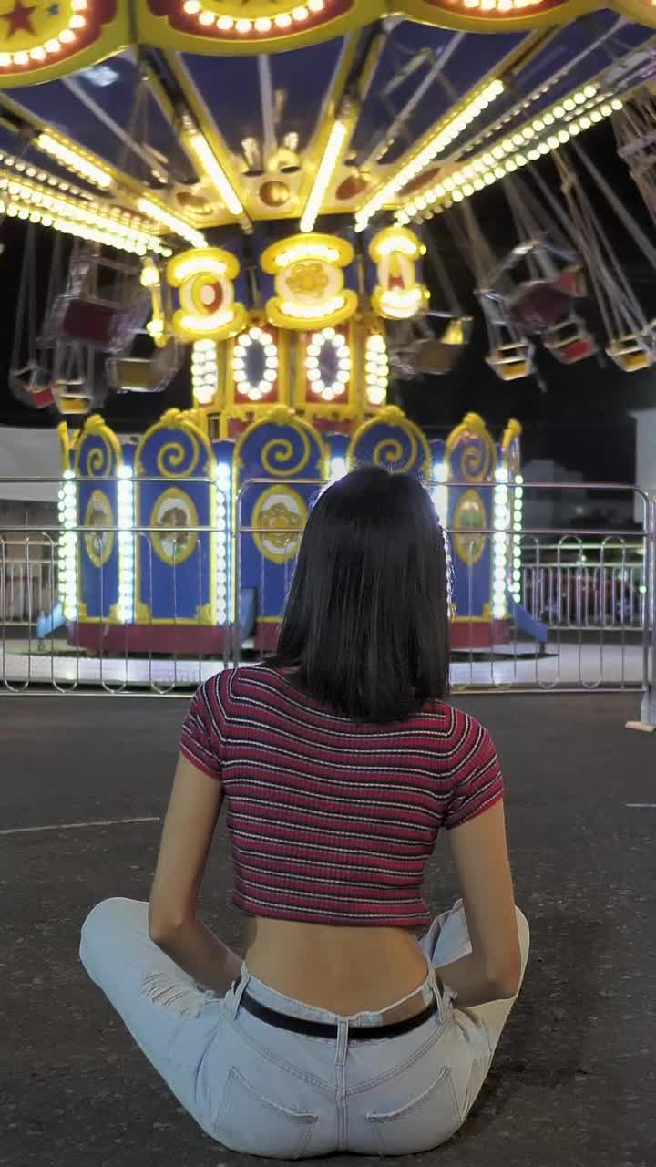 Stock Video Motionless Woman Sitting On The Floor Watching Mechanical Flying Chairs Live Wallpaper - Free Download