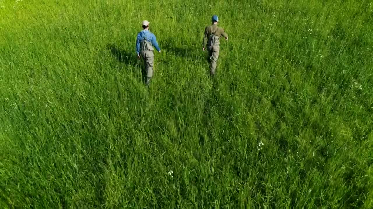 Stock Video Fishermen Walking On Green High Grass Live Wallpaper For PC - Free Download