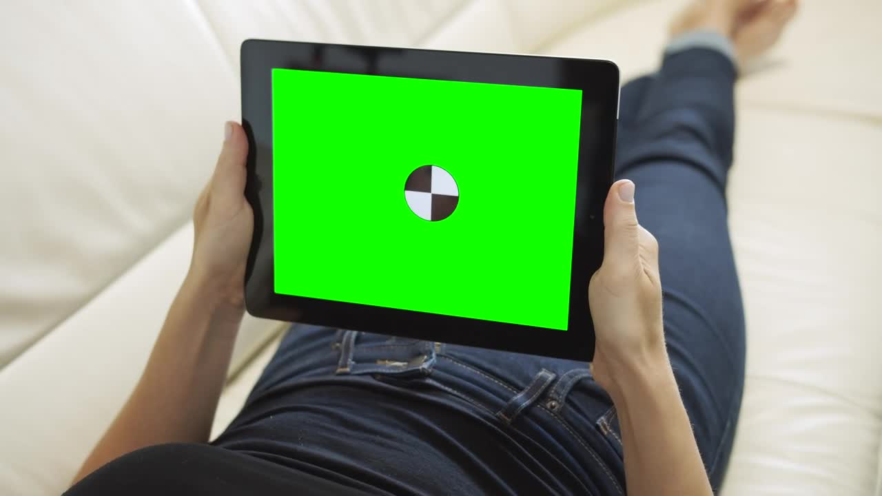 Free Stock Video Relaxing On Sofa Holding Greenscreen Tablet With Chroma Key Live Wallpaper - Free Download