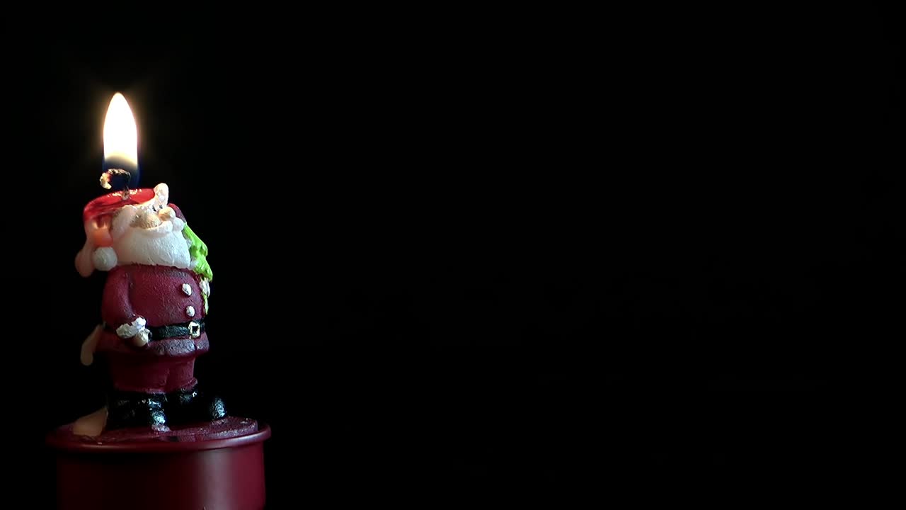 Free Stock Video Santa Claus Shaped Candle On Dark Background Live Wallpaper - Free Download