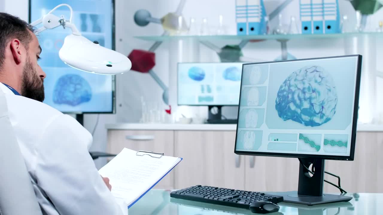Stock Video Doctor Takes Notes While Reviewing Dna And Brain Models Live Wallpaper For PC - Free Download
