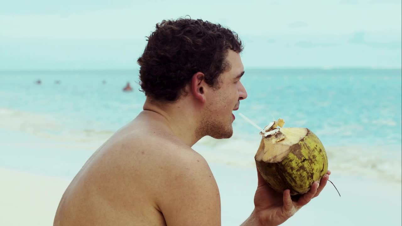 Stock Video Man Drinking From A Coconut Animated Wallpaper - Free Download