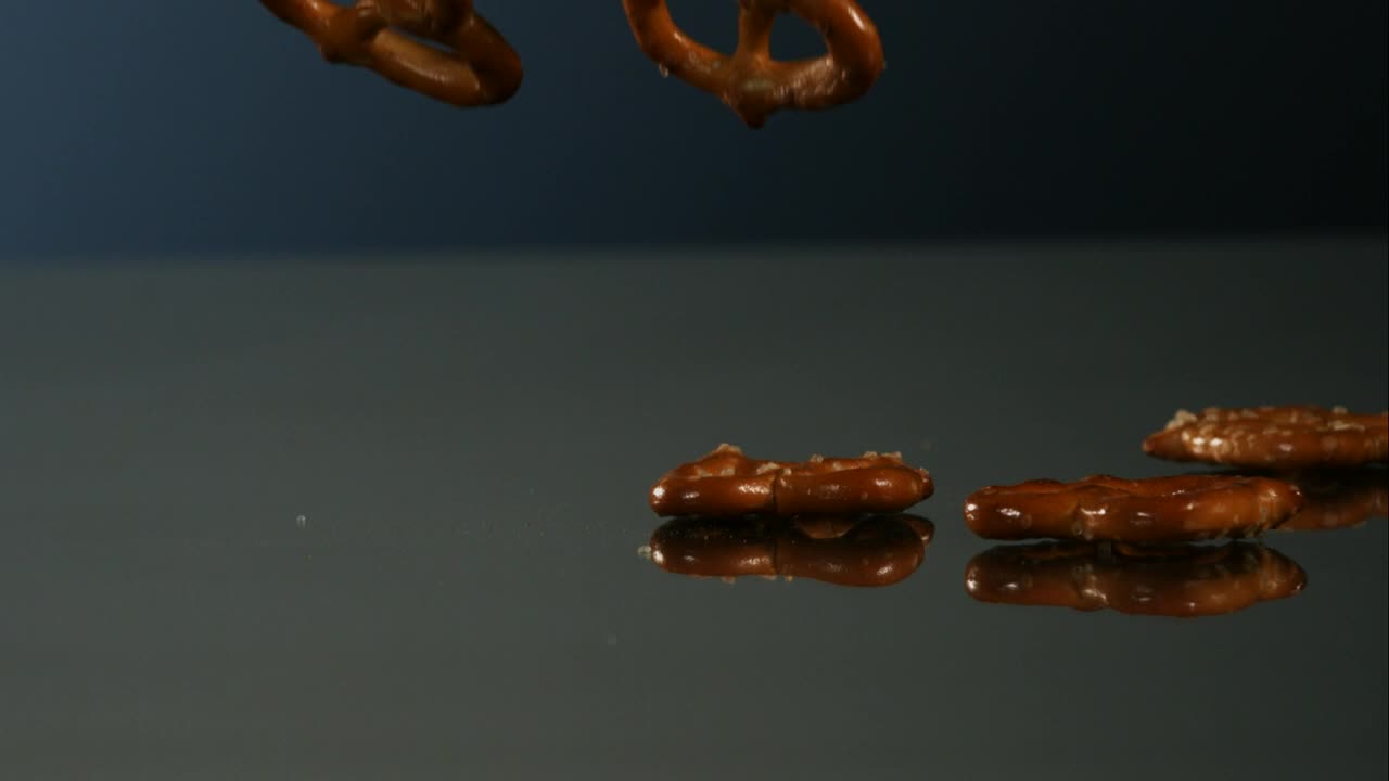 Video Stock Pretzels Falling Into A Mirror Surface Live Wallpaper Free - Free Download