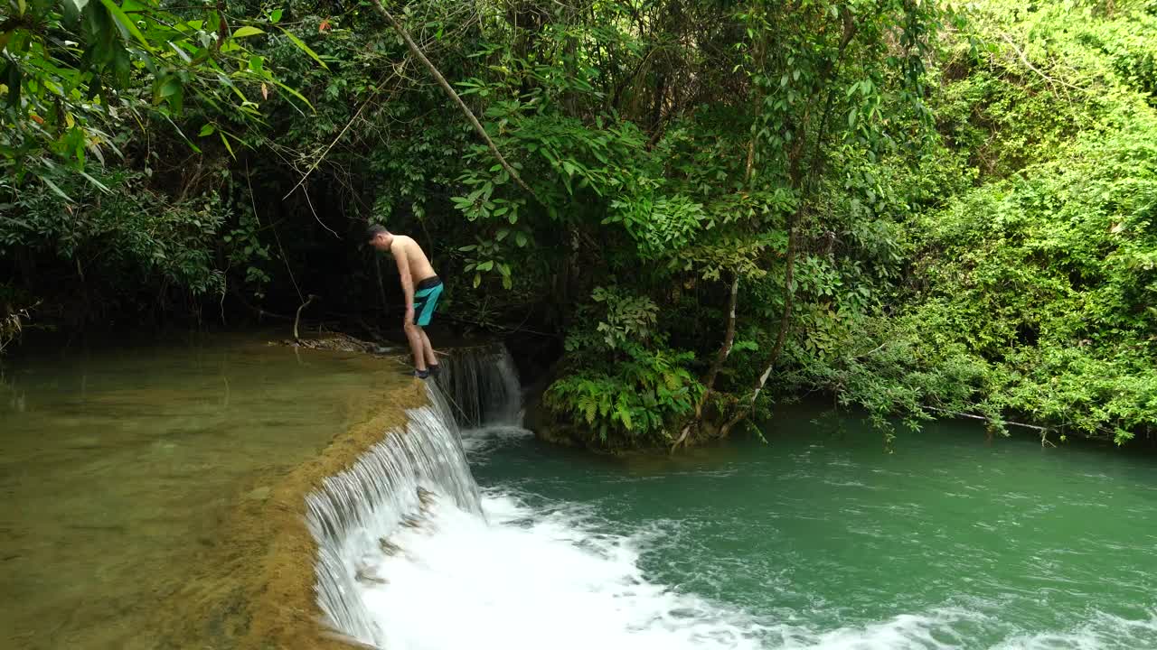 Stock Video Man Dives Into A Small Waterfall Animated Wallpaper - Free Download