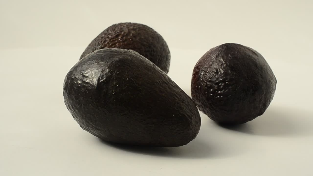 Free Video Stock three avocados rotating on a white background Live Wallpaper - Free Download