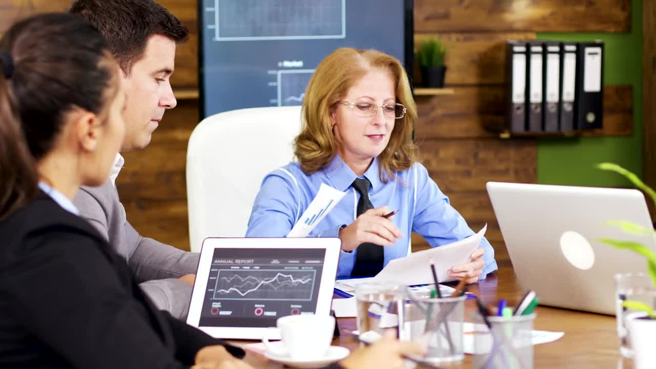 Free Video Stock team leader hands out growth charts at meeting Live Wallpaper - Free Download