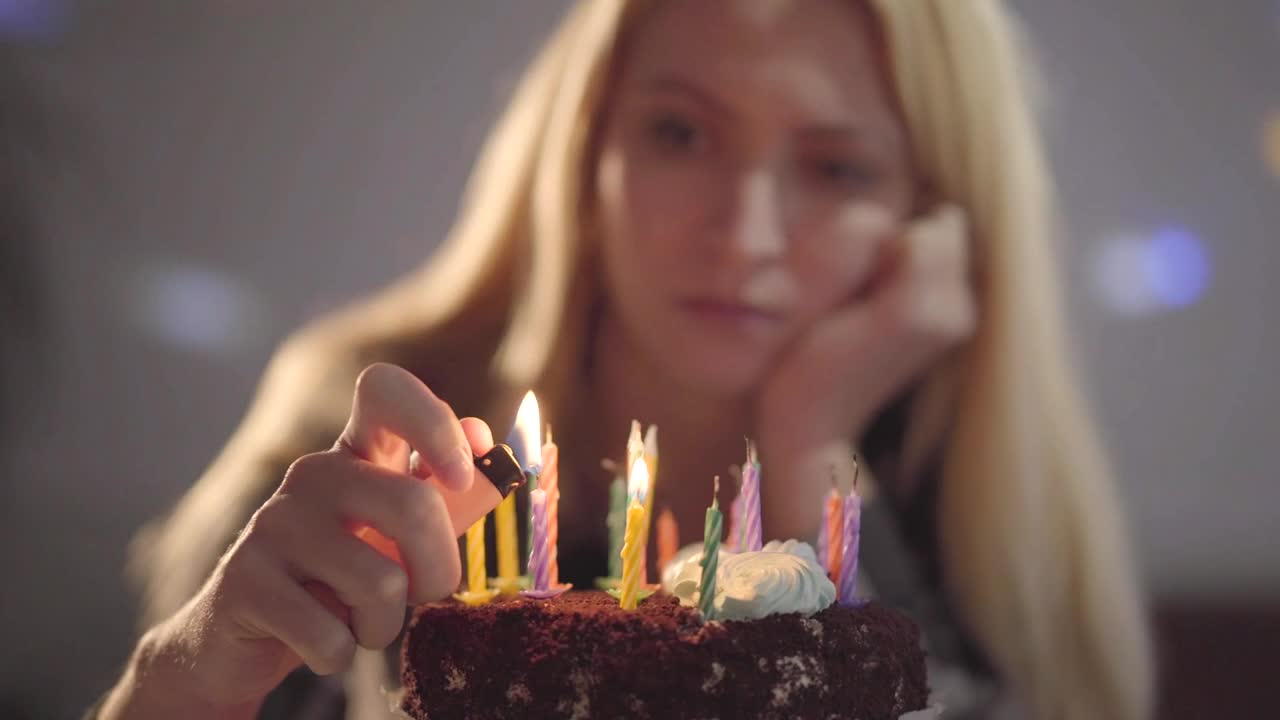 Stock Video Lonely Woman Lighting Candles On Her Birthday Cake Animated Wallpaper - Free Download