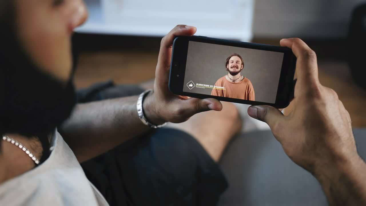 Stock Video Man Watches Social Media Video On Mobile Scree Animated Wallpaper - Free Download