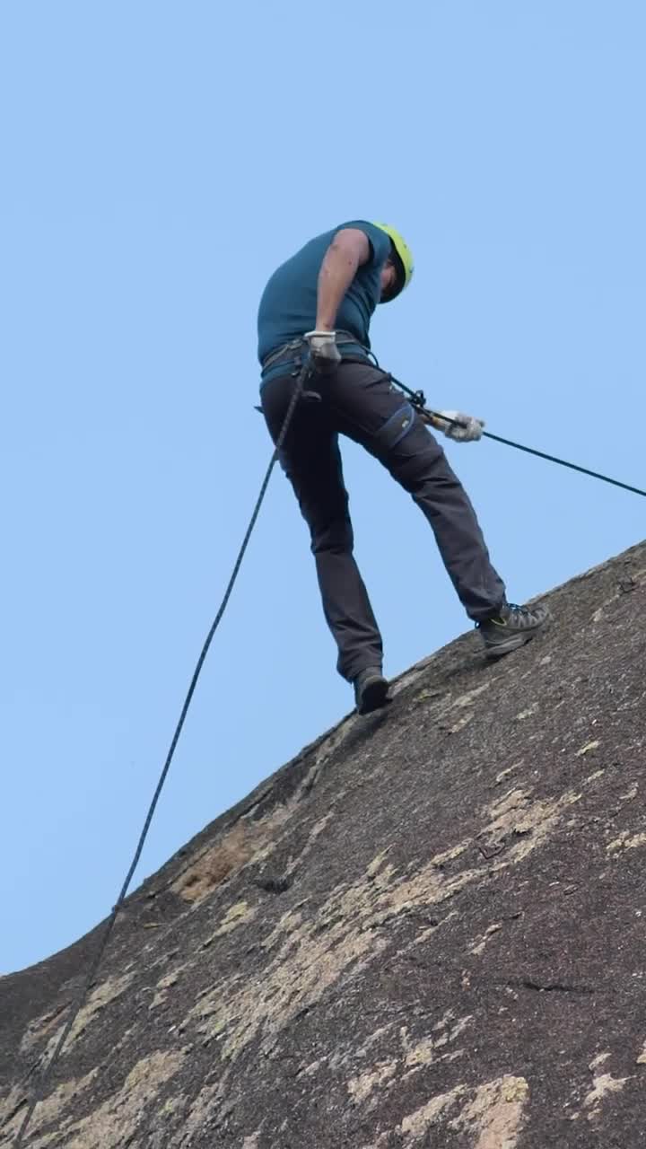 Stock Video Man Slowly Descending Rocky Mountai Animated Wallpaper - Free Download