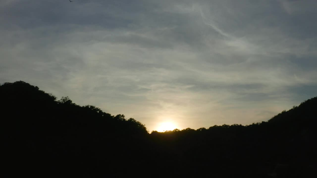 Free Video Stock sunset from the top of a rocky tree covered shoreline Live Wallpaper - Free Download