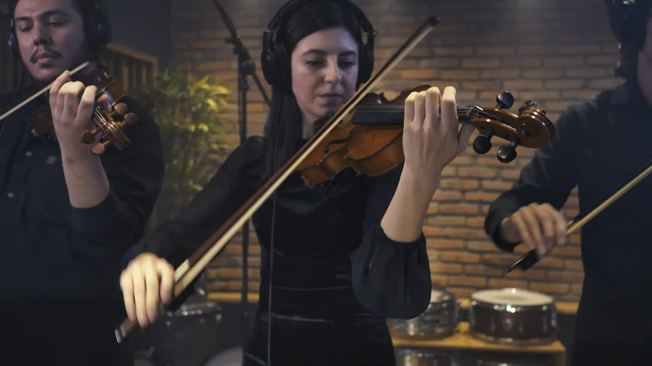 Free Video Stock three violinists recording a song in a studio Live Wallpaper - Free Download