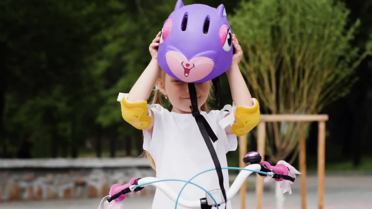 Stock Video Little Girl Puts On A Protective Bicycle Helmet Animated Wallpaper - Free Download