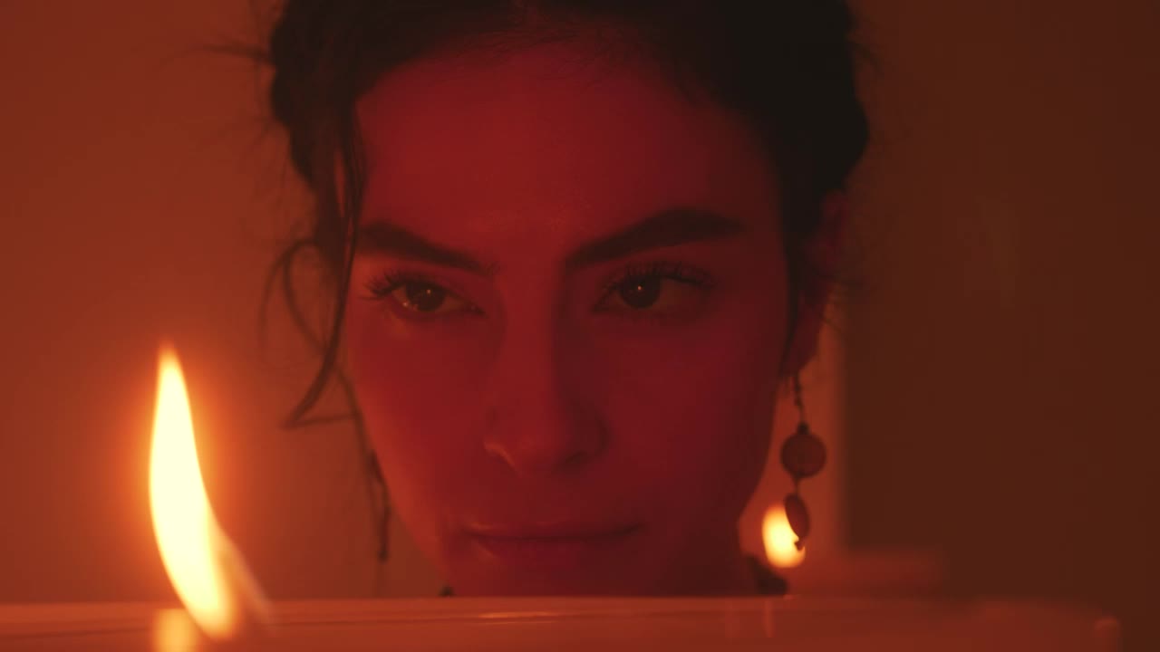 Stock Video Face Of A Spiritual Woman Looking At The Flame Of Live Wallpaper For PC - Free Download